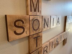 wooden blocks spelling the names of different countries on a wall in a room with white walls