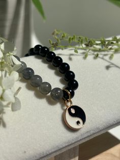 Product details:  * 6mm beads  * Genuine gemstones  * Stretchy cord  * Gold plated enamel Yin Yang charm A beautiful and thoughtful gift idea!  Please don't hesitate to contact me if you have any questions or would like a custom size! 🥰 Minimalist Gemstone Beaded Bracelets For Meditation, Spiritual Jewelry With 108 Beads For Everyday, Everyday Spiritual Jewelry With 108 Beads, Obsidian Beaded Bracelets As Gift, Handmade Black Beaded Bracelets, Handmade Holistic Black Beaded Bracelets, Obsidian Beaded Bracelets With 8mm Beads As Gift, Symbolic Beaded Bracelets With Natural Stones For Meditation, Symbolic Round Beaded Bracelet As Gift