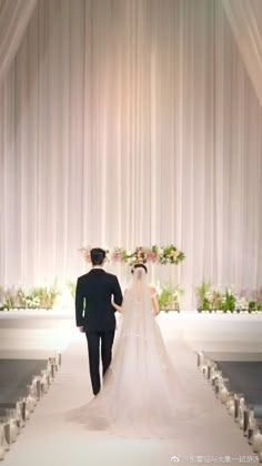 the bride and groom are walking down the aisle