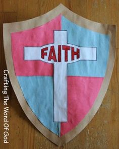 a paper shield with the word faith on it