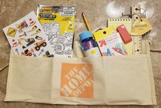 the back pocket of a bag filled with school supplies and stationery on top of a marble floor