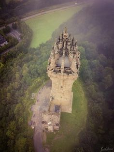 an aerial view of a castle surrounded by trees