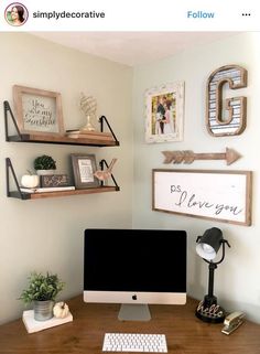 a desk with a computer and some pictures on the wall