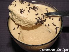 a scoop of ice cream with sprinkles on it in a glass bowl