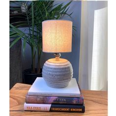 a table lamp sitting on top of two books