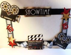 a sign that says show time with some movie stars and clapsticks on it