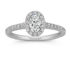 an oval shaped diamond engagement ring with pave set shoulders