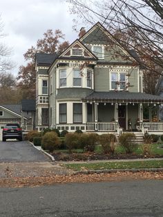 a car parked in front of a two story house