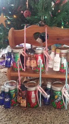 a shelf filled with jars and candy canes next to a christmas tree in the background