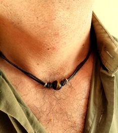 Surfeur style choker necklace made with natural tiger eye stone bead and brown wax cotton cord, stainless steel lobster clasp closure. All metal components are stainless steel. Simple every day cord necklace for men, brown stone choker for him.  Mens minimalist rope necklace a perfect gift for him. Tiger eye bead cord necklace, choker necklace for him, boyfriend gift. Tiger eye stone beads: 12 mm Tigers Eye is good for growing your confidence and strength and it is known as the stone of courage. It is a root and sacral chakra stone which means it helps you to get grounded, build a safe and strong foundation, and find your motivation once more. It's also good at warding off negative energy.  /Gift wrapping and packaging/ :   All items ordered will be placed in a gift bag and shipped in a bu Beach Jewelry For Men, Mens Beaded Necklace, Necklace Men’s, Men’s Necklaces, Men’s Jewelry, Mens Bracelet Diy, Mens Necklace Fashion, Mens Choker Necklace, 90s Choker