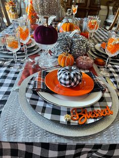 a table set for halloween with pumpkins, candy balls and other decorations on it