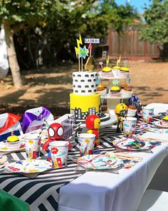 a table topped with lots of cake and cupcakes