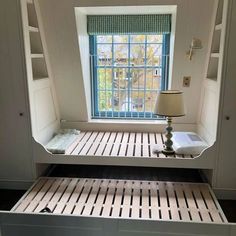 an empty bed frame in front of a window