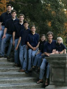 a group of people are posing on some steps