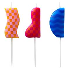 three colorful lollipops sitting on top of each other in the shape of shapes