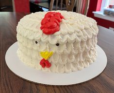 a cake decorated with white icing and red flowers