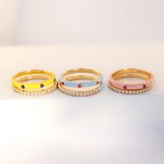 This is a great ring to wear on its own but works even better in a stack. You can really make a whole rainbow of colors on your finger with just a couple of rings! Let’s play! Precious Metal: 18K Solid Yellow Stones: Pink Sapphire with Baby Blue Enamel, Ruby with Peach Enamel or Blue Sapphire with Neon Yellow Enamel .05ct each design Enamel Colors: Baby Blue, Peach or Neon Yellow Sizes: 7 Width: 2.4mm Other rings shown on the pictures are sold separately. Wear with care and avoid harsh chemicals Yellow Enamel Ring, Pink Open Enamel Ring, Pink Enamel Ring Fine Jewelry, Enamel Multi-stone Rings As A Gift, Gold Enamel Ring With Multi-stone, Mini Necklace, Dad Jewelry, Gold Diamond Jewelry, Blue Peach