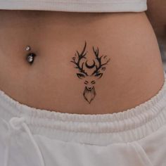 a woman with a deer tattoo on her stomach