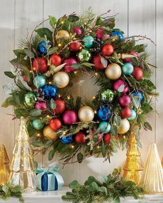 a christmas wreath with ornaments around it