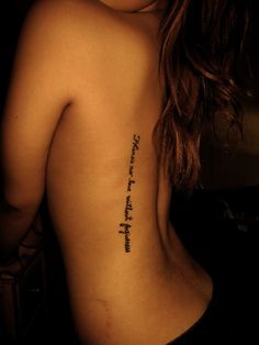 the back of a woman's body with a tattoo saying, there is no love without