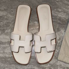 Only Worn Once And Unfortunately My Puppy Bite One Sandal Which You Guys Can See Is Slight Defective Other Than That The Sandals Are 100% Authentic, Dust Bags Included. White Hermes Oran, Hermes Oran Sandals, Puppy Biting, My Puppy, Hermes Shoes, Hermes Oran, Shoes White, Women's Shoes Sandals, Shoes Sandals