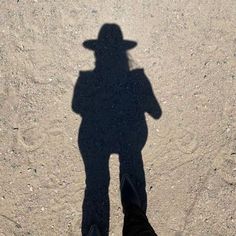 the shadow of a person wearing a hat