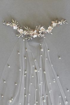 a bridal veil with flowers and pearls