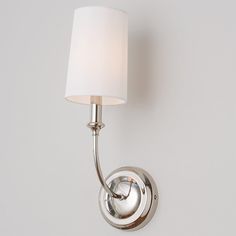 a wall light with a white shade on it