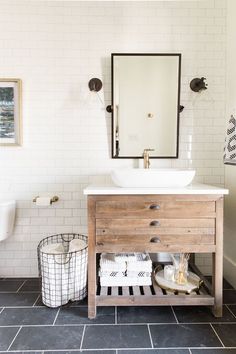 a bathroom with a sink, mirror and toilet