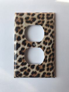 a leopard print light switch plate cover on a white surface with an animal print pattern