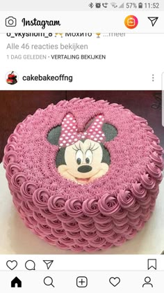 the cake is decorated with pink icing and has a minnie mouse face on it