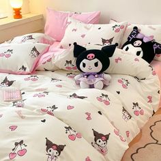 a bed with pink and white sheets, pillows and stuffed animals on it