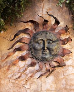 a sun face on the side of a wall