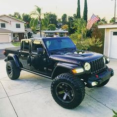 a black jeep parked in front of a house