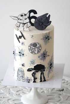 a star wars themed birthday cake on a white tablecloth with an ornament