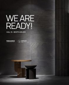 an advertisement for a new furniture store called we are ready, featuring two round tables in front of a black wall