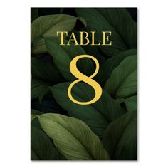 the table number 8 is surrounded by green leaves