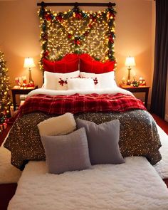 a bedroom decorated for christmas with lights on the headboard and bed in front of it