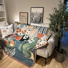 a living room filled with furniture and pictures on the wall next to a potted plant