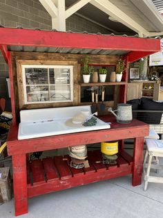 an outdoor kitchen with potted plants on the counter