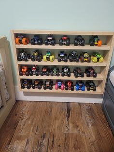 there is a toy car display on the wall next to a child's bed