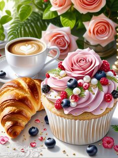 there is a cupcake with flowers on it and a croissant next to it