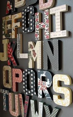 the letters are made out of wood and have polka dot designs on them, as well as flowers