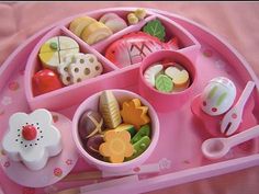 a pink tray filled with lots of food