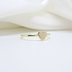 An all-gold and shiny heart will adorn your hand  🤍🤍 🤍 Details  The heart's size is 5,7mm. x  5,8mm. (approx.) and  thickness of heart is 1,00mm.(approx.) The band's thickness is 1,30mm.(approx.)  flat on the inside and slightly curved on the outside. 🤍 Materials All our items are made of 9 karats, 14 karats, or 18 karats solid gold upon request. We like to use yellow gold, white gold, and rose gold to please your color of choice. Use the drop-down material menu to find your favorite option. 14k Gold Stackable Rings With Heart Charm, Gold 14k Heart-shaped Stackable Rings, Gold Heart-shaped Stackable Rings, Gold Heart-shaped Midi Rings With Heart Charm, 14k Gold Heart Shaped Stackable Rings, Heart-shaped 14k Gold Stackable Promise Rings, Yellow Gold Heart Charm Promise Ring, 14k Gold Rings With Heart Charm And Heart Cut, Rose Gold Heart Charm Promise Ring