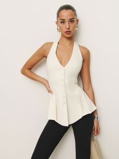 Up top. Shop the Auli Top from Reformation, a sleeveless vest top. It has a deep-v halter neckline, button front, and peplum-style hem. White Sleeveless Vest, Leggings And Heels, Work Wear Outfits, Peplum Styling, Peplum Styles, Swimwear Dress, Stylish Work Outfits, Vintage Inspired Dresses, White Sleeveless