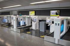 an airport baggage claim area with several machines