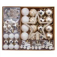 an open box filled with christmas ornaments and silver decorations on top of eachother