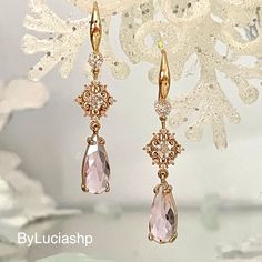 Step into the glamor of yesterday with our Elegant Art Deco Earrings - a symphony of style and romance.  These tear-shaped beauties, adorned with blush pink crystals and sparkling cubic zirconias, exude bohemian charm and timeless elegance.  The long crystal drop design, plated in champagne gold (18k gold plated), adds a touch of sophistication to any outfit. Ideal for the woman who appreciates glamor and style, these earrings feature faceted pastel pink crystals that delicately catch and reflec Elegant Pink Chandelier Earrings For Formal Occasions, Elegant Pink Chandelier Earrings For Formal Events, Elegant Pink Dangle Crystal Earrings, Elegant Pink Teardrop Chandelier Earrings, Pink Gold Dangle Earrings For Wedding, Pink Gold Dangle Jewelry For Wedding, Elegant Pink Crystal Bridal Earrings, Elegant Pink Dangle Chandelier Earrings, Elegant Pink Crystal Earrings