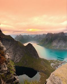 a bird sitting on top of a rock next to a body of water and mountains